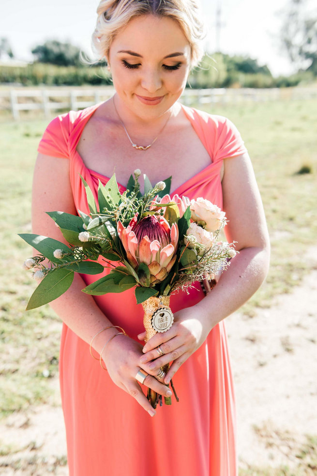 Protea Bouquet and peach bridesmaid dress /Langkloof Roses Wedding, Cape Town - Claire Thomson Photography