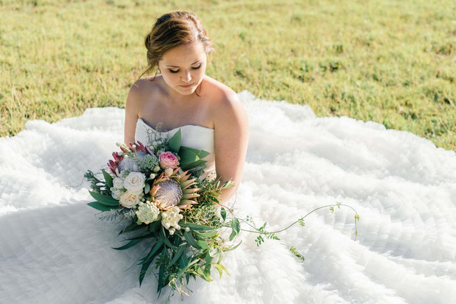 Bride with protea cascade bouquet / Langkloof Roses Wedding, Cape Town - Claire Thomson Photography