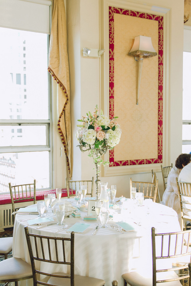 White hydrangea, cream and blush roses, white lillies, ivy wedding floral centerpiece