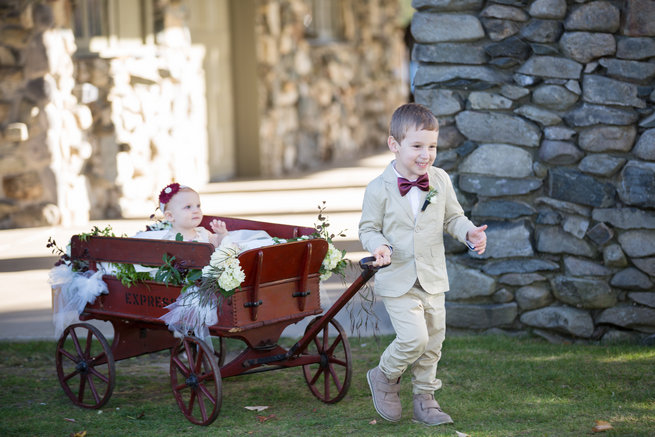Ringbearer carrying flower girl in floral cart - love this!  - Beautiful Burgundy and Tan Wedding - Molinski Photo