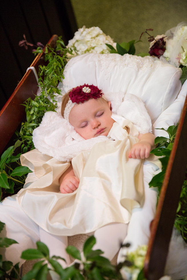 Flower girl sleeping in floral cart - Beautiful Burgundy and Tan Wedding - Molinski Photo