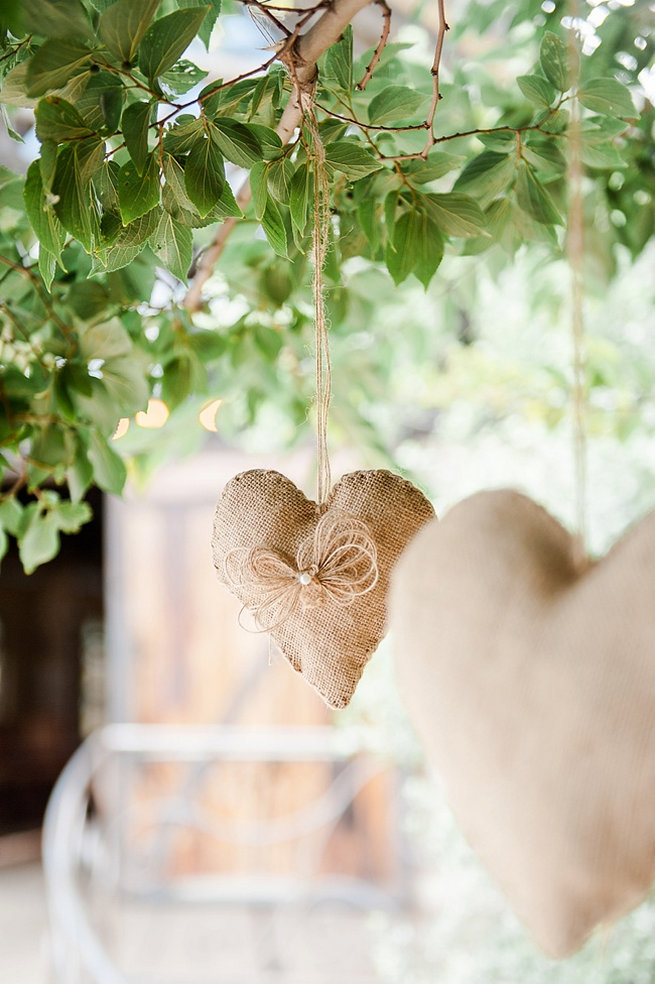 Hanging burlap wedding ceremony hearts. Coral and Green South African Wedding // D'amor Photography