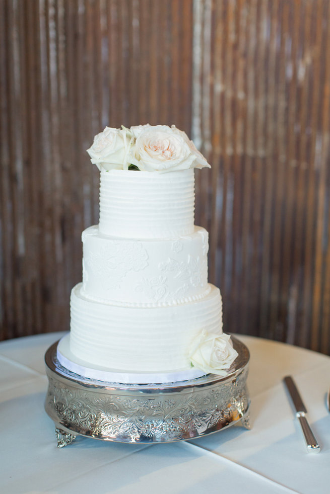 All white wedding cake with fresh flowers. Modern Urban Wedding at Old Cigar Warehouse / Ryan and Alyssa Photography