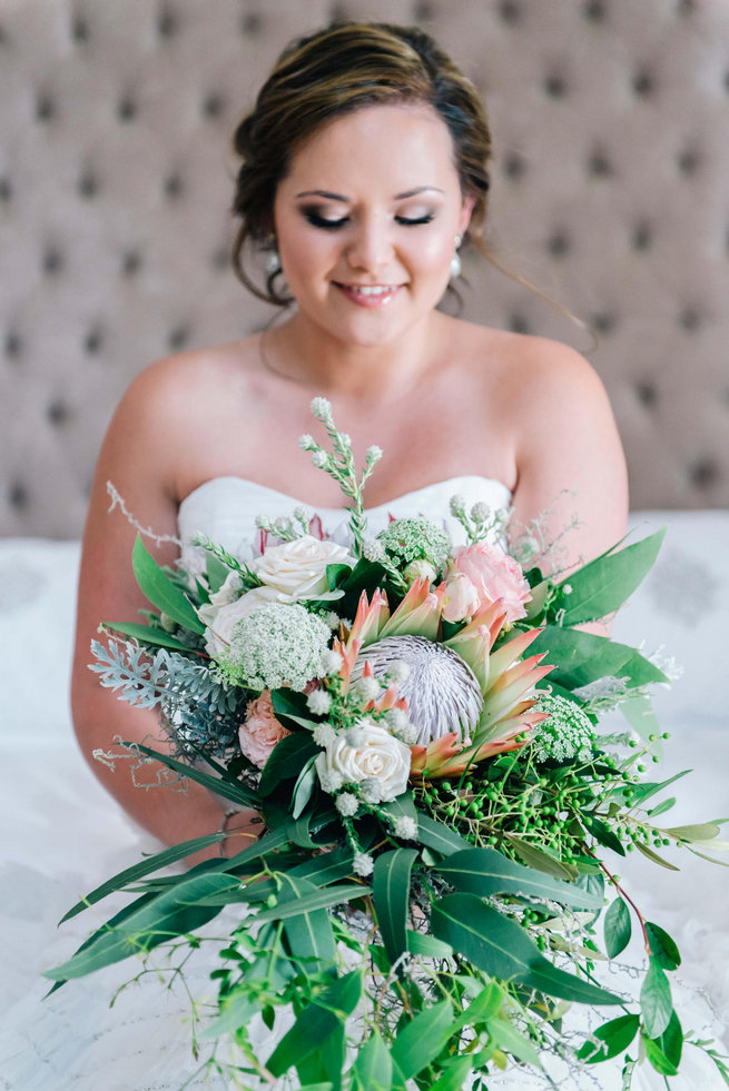Breathtaking Wedding Bouquet: Cascading King Protea, Jasmine, Eucalyptus, rose and queen anne's lace bouquet. Click to blog for more gorgeous bouquet ideas.