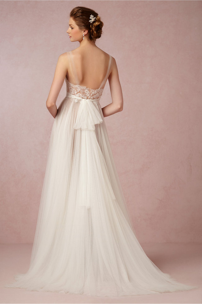 Chic, Sophisticated Wedding Dresses for Romantics: The Penelope gown has all the elements of a fairytale gown: soft illusion neckline, floral-covered bodice, flowing tulle skirt, sweeping train, and a sash to tie it all off.