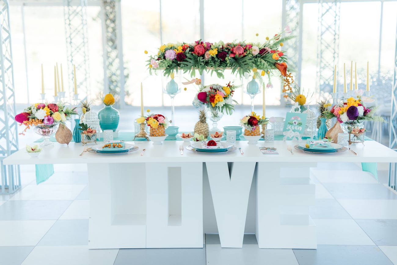 The LOVE sign makes the tropical sweetheart table even more perfect. Click for the most absolutely gorgeous Tropical Wedding ideas ever!
