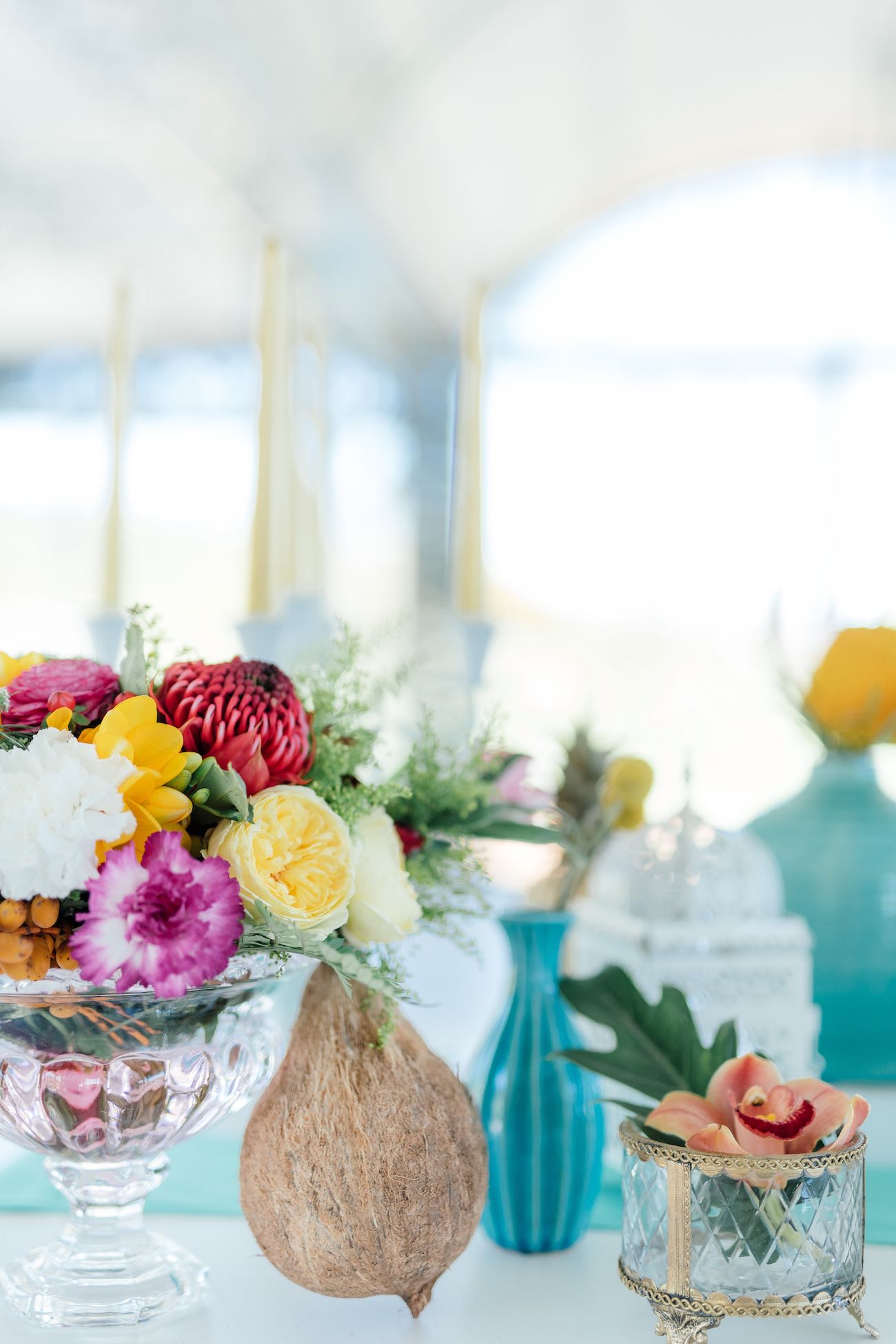 Yellow garden roses, red Protea, yellow tulips, pink blooms and ferns for a tropical wedding theme. Click for the most absolutely gorgeous Tropical Wedding ideas ever!