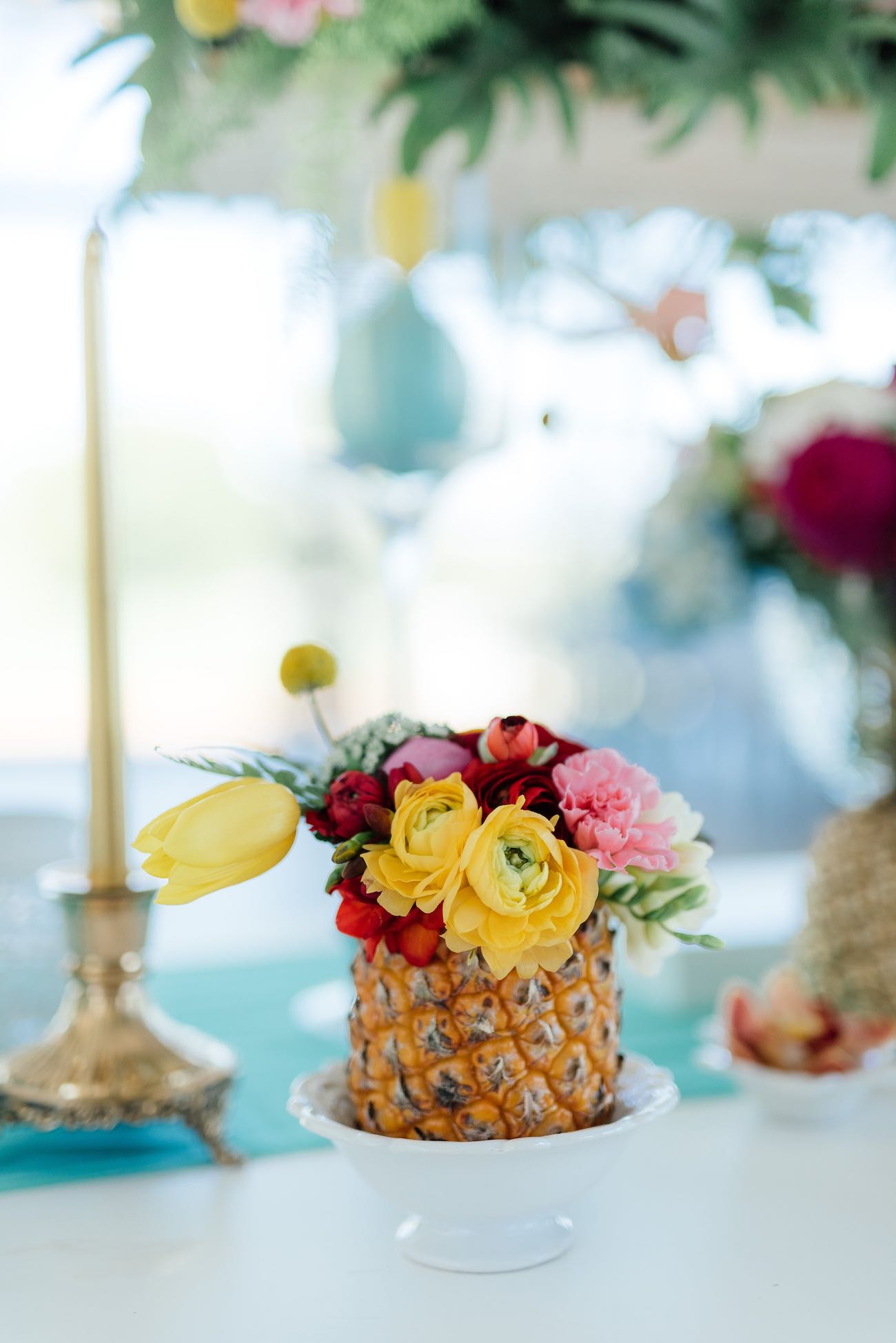 Pineapple filled with flowers: roses, ranunculus, tulips, ferns and crespidia. 