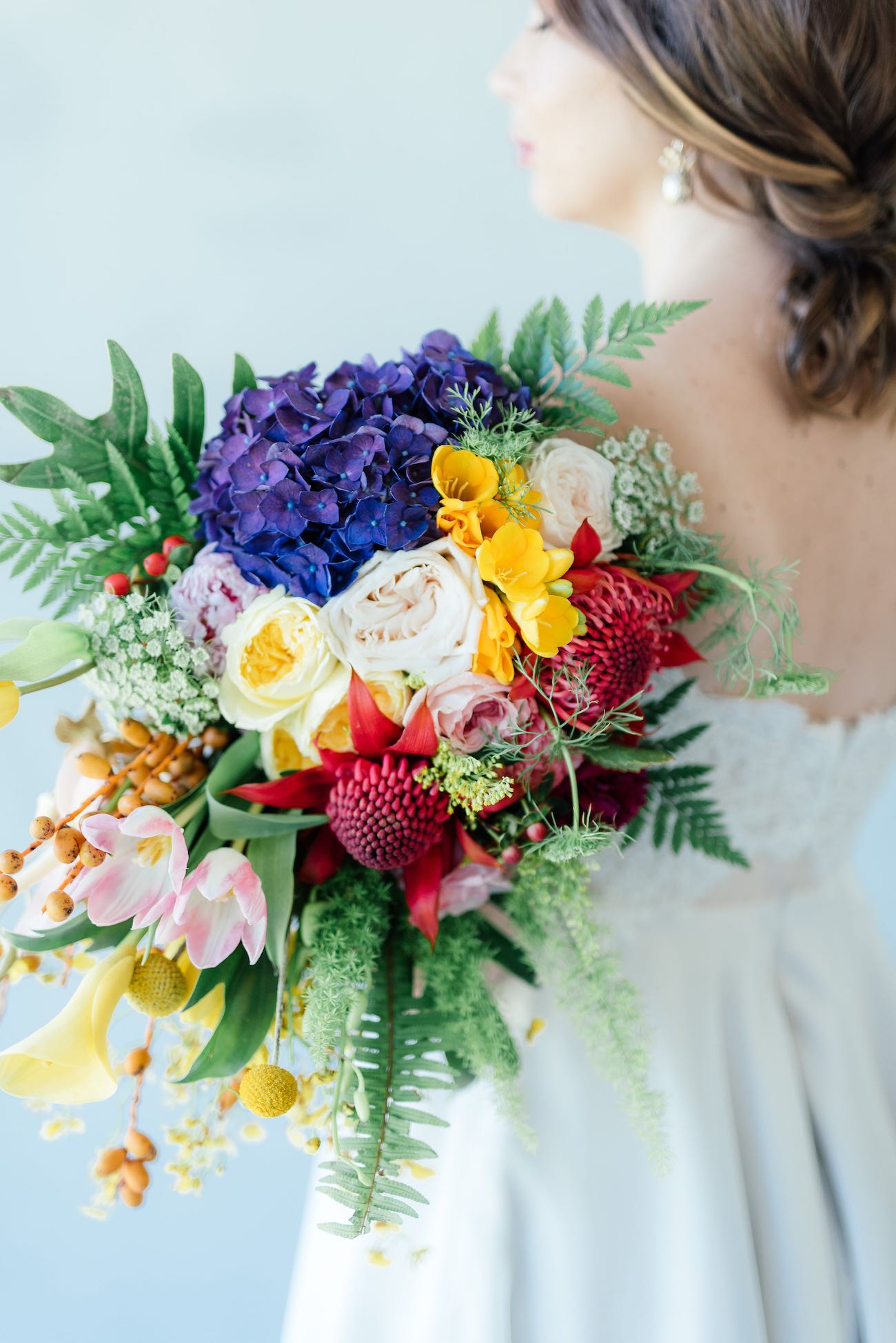 STUNNING tropical wedding bouquet made from a cascade of bright blue hydrangea, yellow lilies, ferns, tulips. roses, queen annes lace, billies balls, protea and beautiful blooms! Super cute "tutti frutti", Carmen Miranda style tropical flower crown for a tropical bride in bright colors. Fun and cute. Tropical Wedding Ideas photographed by Debbie Lourens Photography