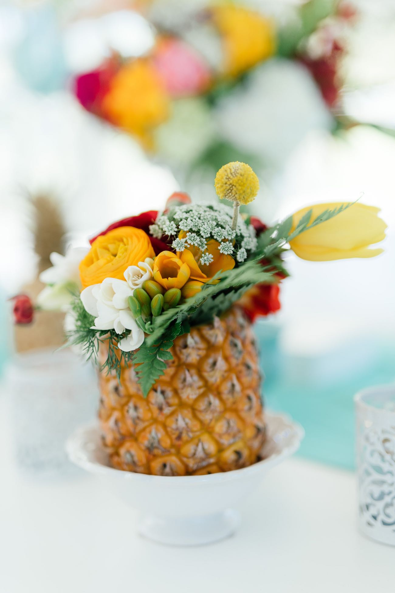 Pineapple filled with tropical flowers. Click for the most absolutely gorgeous Tropical Wedding ideas ever!