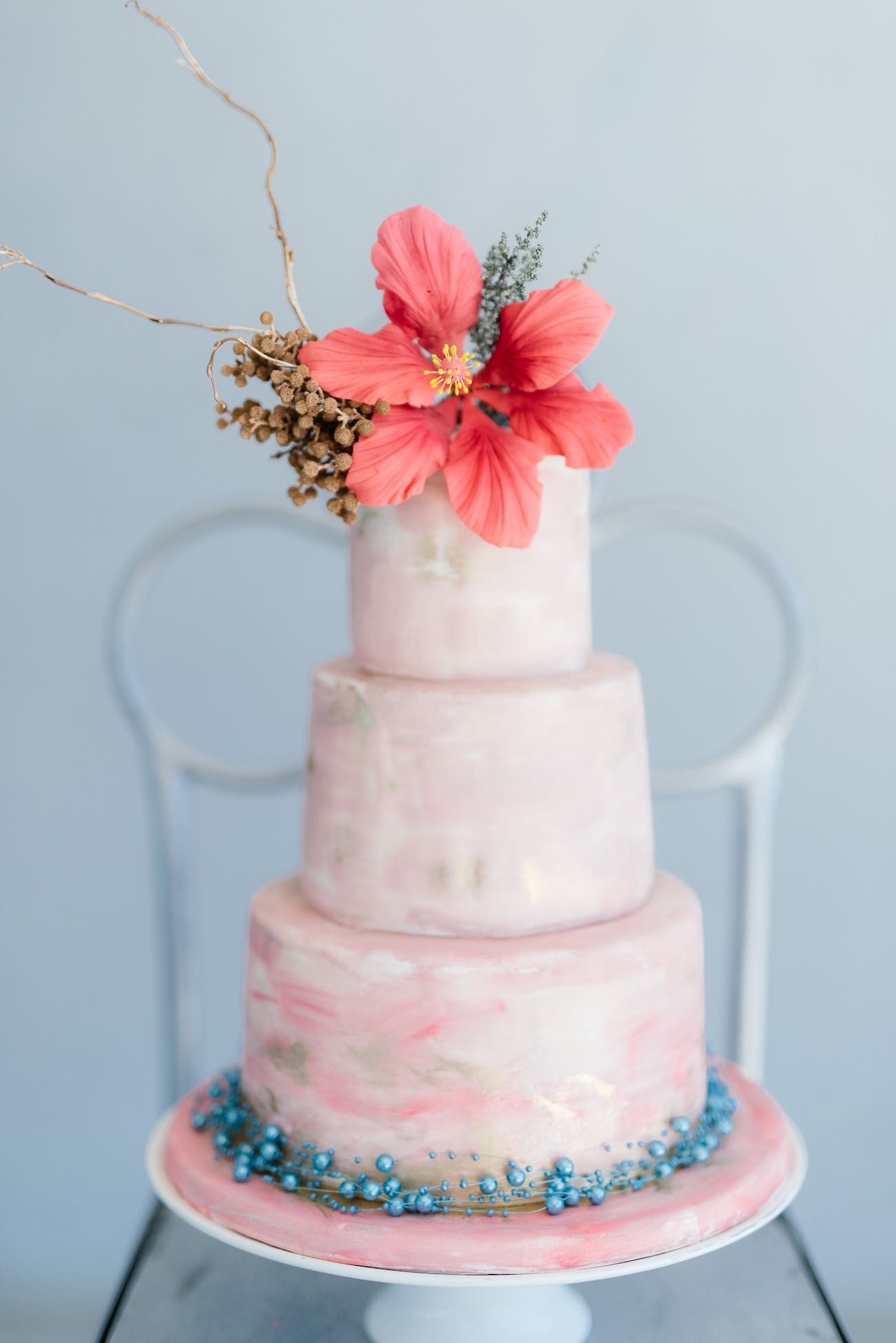 Soft pink tropical wedding cake with touches of gold and a hibiscus flower topper. Hand painted, watercolor. Click for the most absolutely gorgeous Tropical Wedding ideas ever! 